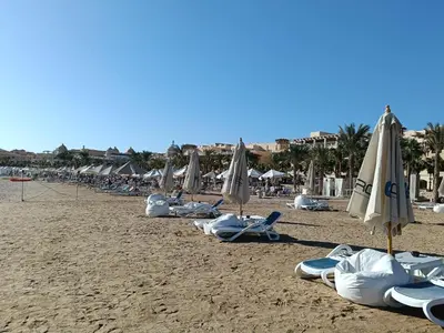a group of chairs and umbrellas on a beach at EDElma in Hurghada