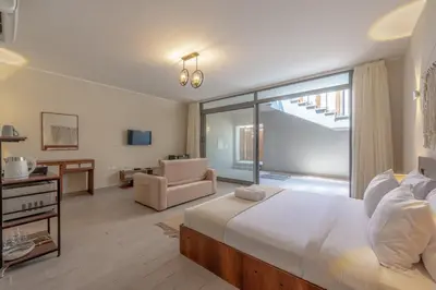 a bedroom with a large bed and a living room at Soulful Studio in Bali El Gouna in Hurghada
