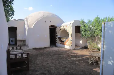 an outside view of a white building with a dome at House of Tranquility in Al Aqālitah