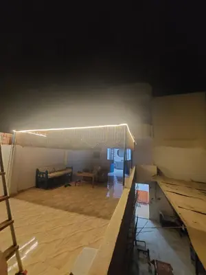 a room with a stage with a wooden floor at Blue Sky Apartments & Restaurant in Luxor
