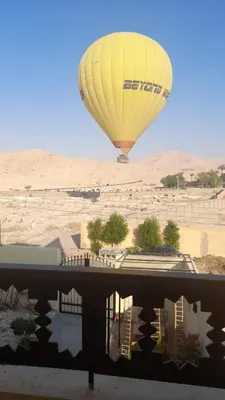 a hot air balloon is flying over a building at Carter Guesthouse Luxor 5 in ‘Ezbet Abu Ḥabashi