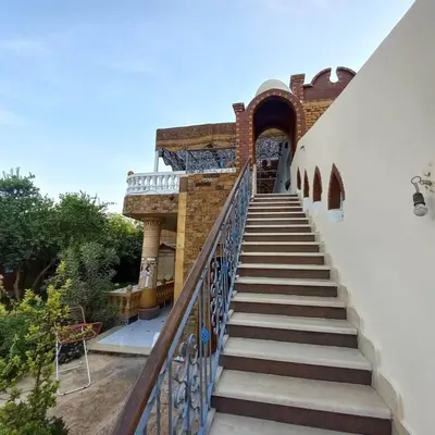 a staircase leading up to a building with a gate at Villa Nicole in Luxor