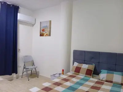 a bedroom with a blue bed and a chair at شارع عربيه ع البحر مول السلام أمام مستشفي السلام in Hurghada