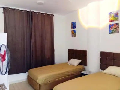 a bedroom with two beds and a window at شارع عربيه ع البحر مول السلام أمام مستشفي السلام in Hurghada