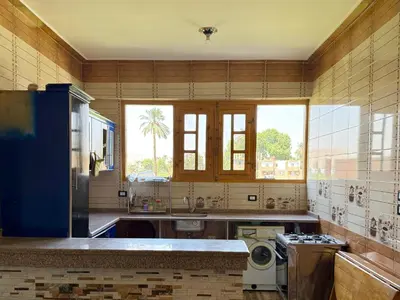 a kitchen with a sink and a washing machine at El Fayrouz Guesthouse Luxor in Luxor