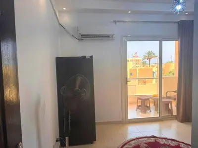 a room with a fan on the wall and a window at Home 2 Bedroom in Hurghada in Hurghada