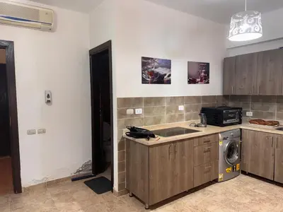 a kitchen with a sink and a washing machine at Modern 1bedroom in Hurghada in Hurghada