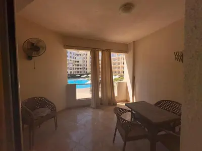 a dining room with a table and chairs and a window at Modern 1bedroom in Hurghada in Hurghada