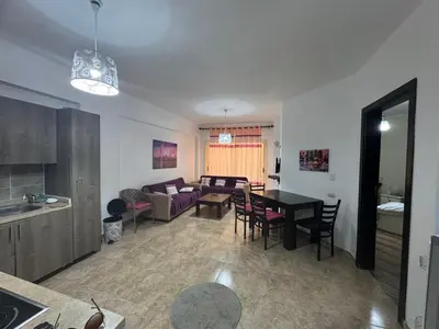 a living room with a table and a couch at Modern 1bedroom in Hurghada in Hurghada
