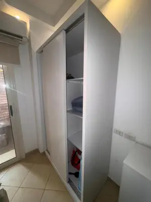 a white closet with a door open in a room at Cozy Studio in Hurghada in Hurghada