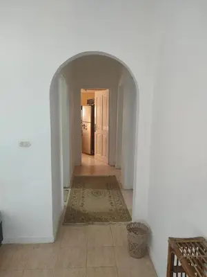 a hallway with an archway in a house with a rug at Apartment Sama Beach in Hurghada