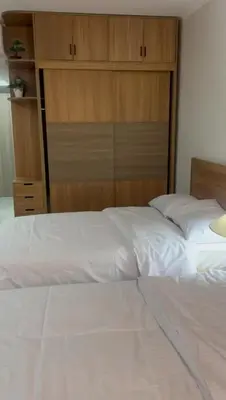 a bedroom with a large white bed and wooden cabinets at Scandic resort in Hurghada