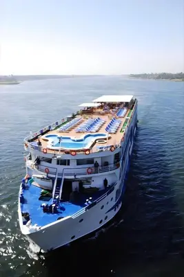 a large cruise ship floating in the water at Nile cruise from Luxor to Aswan 4 nights From Aswan to Luxor 3 nights in Luxor