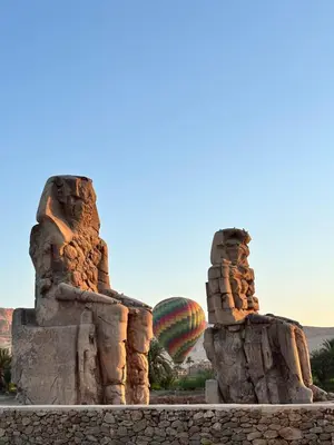 a hot air balloon in the sky over a rock formations at Luxor temple view in Luxor