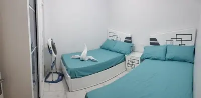 a room with two beds in a hospital room at Hurghada Seafront Family Apartment with Pool View in Hurghada