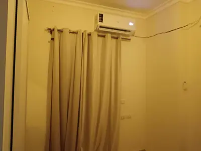 a bathroom with a shower curtain and a air conditioner at شقق وشاليهات ايجار in Hurghada