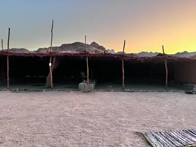 a building in the desert with mountains in the background at Scenery Khalaf malky in Hurghada