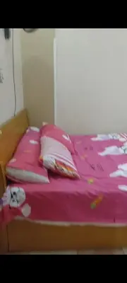 a bed with a pink blanket and pillows on it at الغردقه الوفاء in Hurghada