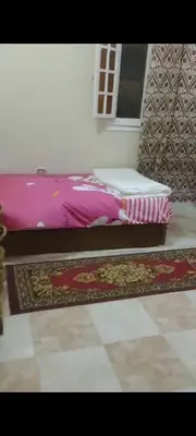 a bedroom with two beds and a rug on the floor at الغردقه الوفاء in Hurghada