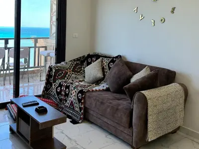 a living room with a couch and a table at Cozy 1-Bedroom Chalet with Sea View in Hurghada