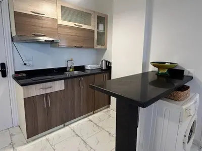 a kitchen with a sink and a counter top at Cozy 1-Bedroom Chalet with Sea View in Hurghada