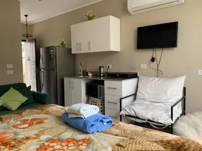 a kitchen with a bed and a kitchen with a stove at استوديو أنيق في الجونة in Hurghada