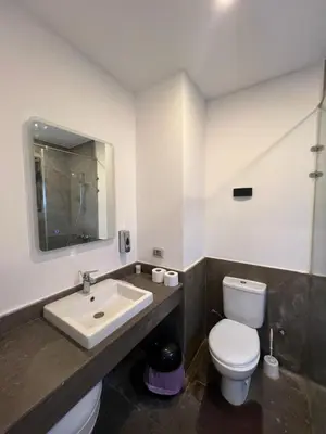 a bathroom with a white toilet and a sink at شاليه بالي بمسبح خاص مدفأ in Hurghada
