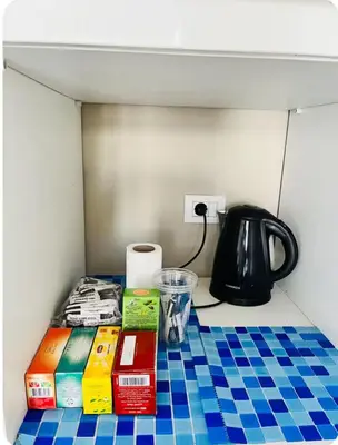 a table with books and a tea kettle on it at شاليه بالي بمسبح خاص مدفأ in Hurghada