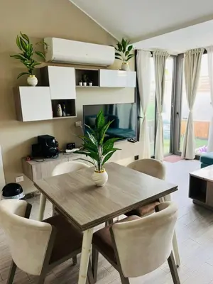 a dining room table with chairs and a television at شاليه بالي بمسبح خاص مدفأ in Hurghada