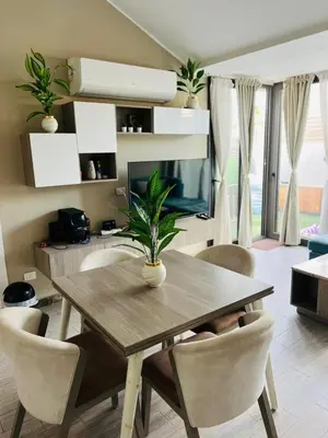 a dining room table with chairs and a television at شاليه بالي بمسبح خاص مدفأ in Hurghada