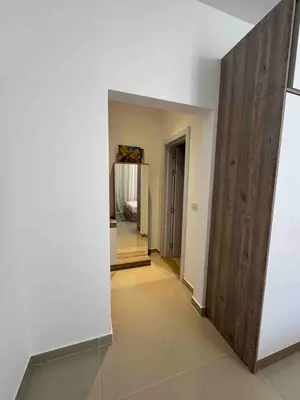 a hallway with a white wall and a wooden partition at G Crips View in Hurghada