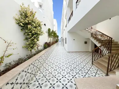 a hallway of a building with a tile floor and stairs at Arabian Suites by Imperial 1 bed Apartment in Hurghada