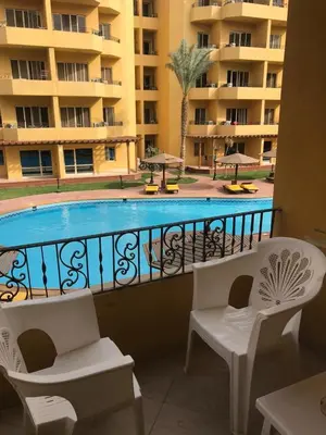 a balcony with a view of a swimming pool at Premier group in Hurghada