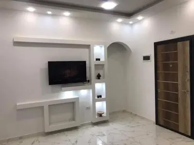 a living room with a flat screen tv on a wall at Premier group in Hurghada