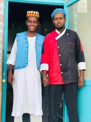 two men are standing next to each other at ISIS Hostel in Aswan