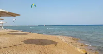a kite flying over the ocean on a beach at Selena bay 006 in Hurghada