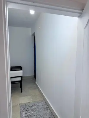 a hallway with a desk and a white wall at Desert Pearl Studio Retreat in Hurghada