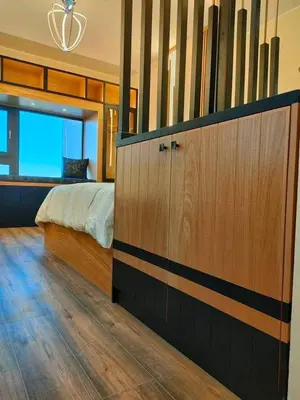 a bedroom with a bed and a wooden cabinet at Chalet in Hurghada