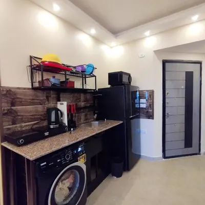 a kitchen with a washing machine in a room at Princess Resort, Hurghada in Hurghada