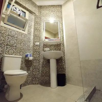 a bathroom with a toilet and a sink and a mirror at Princess Resort, Hurghada in Hurghada