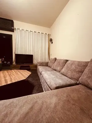 a living room with a couch and a flat screen tv at Azzura Sahl Hasheesh in Hurghada