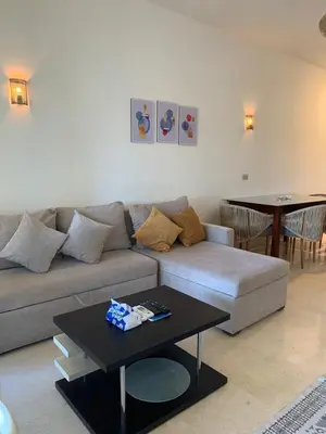 a living room with a couch and a table at Azzura Sahl Hasheesh in Hurghada