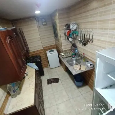 a small kitchen with a sink and a refrigerator at شقة فاخرة اسوان in Aswān