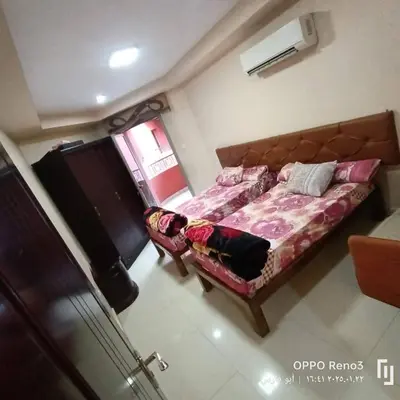 a bedroom with a bed with a dog laying on it at شقة فاخرة اسوان in Aswān