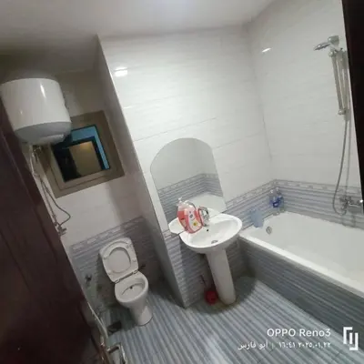a bathroom with a sink and a toilet and a tub at شقة فاخرة اسوان in Aswān