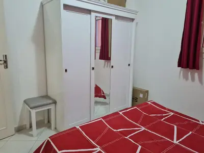a bedroom with a red bed and a mirror at Oasis Resort Soraya - 2 bed apt, recently renovated and fully furnished with pool views in Al Ahyaa Hurghada Egypt in Hurghada