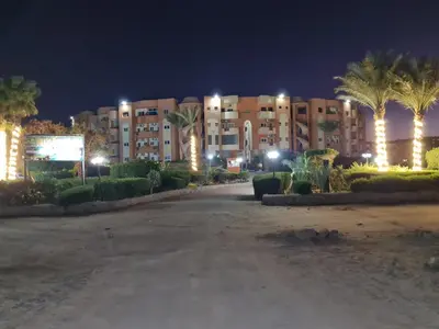 a large building with palm trees in front of it at Oasis Resort Soraya - 2 bed apt, recently renovated and fully furnished with pool views in Al Ahyaa Hurghada Egypt in Hurghada