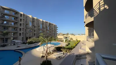 a view of a building and a swimming pool at El princess one bedroom hurghada in Hurghada