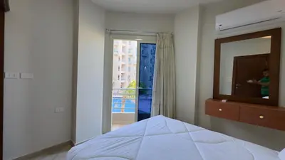 a bedroom with a bed and a mirror and a window at El princess one bedroom hurghada in Hurghada