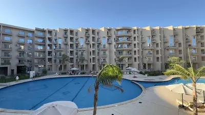 a large apartment building with a large swimming pool at El princess one bedroom hurghada in Hurghada